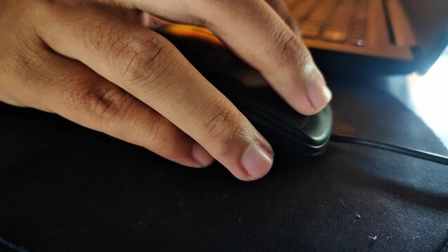 Close-up of a human hand expertly navigating a computer mouse, symbolizing digital interaction and essential modern productivity in a technology-driven environment