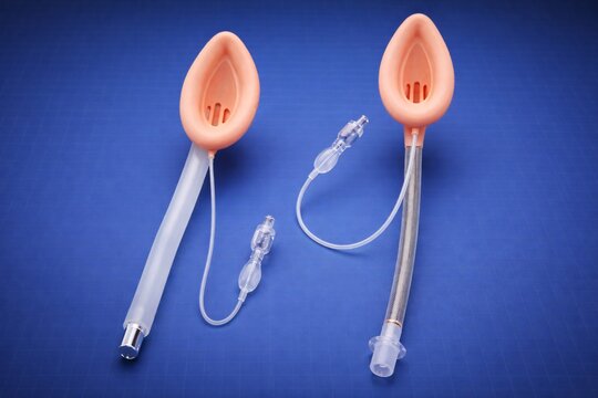 Two different sized laryngeal mask airways displayed on a blue surface, showing essential airway management tools used in anesthesia, emergency ventilation, and clinical medical training.