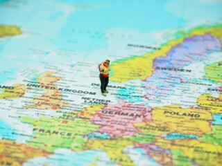 Obraz premium Miniature toy with blurred map as a background.