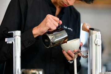 Barista brewing hot coffee at a cafe