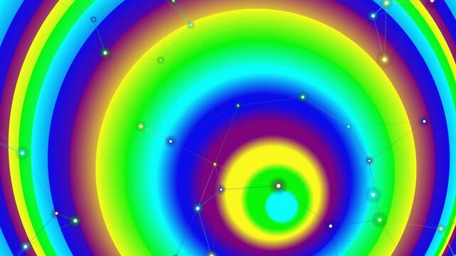 Vibrant concentric circles with a gradient of colors including blue, green, yellow, and purple, set against a white background with small white dots scattered throughout.