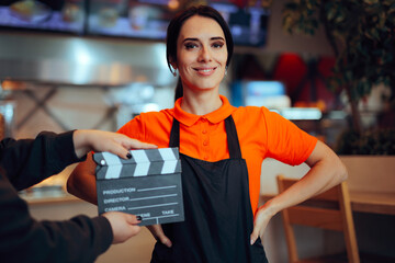 Actress Dressed as a Waitress Films a Scene from a TV Series. Actor in a waiter uniform performing...