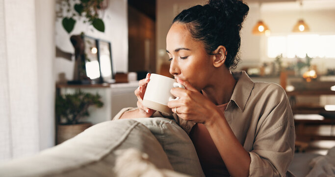 Aroma, coffee and relax with woman on sofa in living room of home for break, chilling or me time. Drink, scent and wellness with calm person in apartment on weekend for beverage, rest or unwind