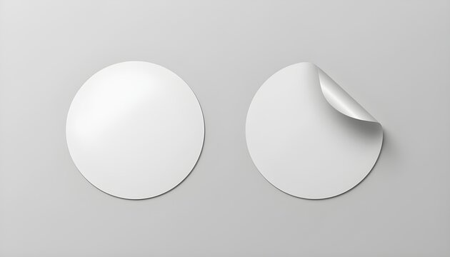 Blank white round adhesive stickers are perfectly arranged on a minimalist light gray background, offering a versatile template for product branding and design mockups, with one sticker featuring a re