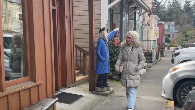 Woman walking on Coupville main street at beautiful winter day.