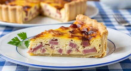 A slice of savory pie on a white plate with blue trim