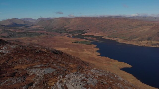 Cinematic aerial footage showing the beginning of Lough Corrib surrounded by the rugged mountains and peatlands of Connemara, County Galway.