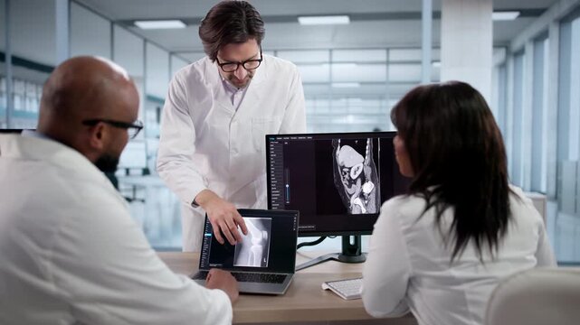 Medical Team Meeting In Classroom Looking At MRI Scans