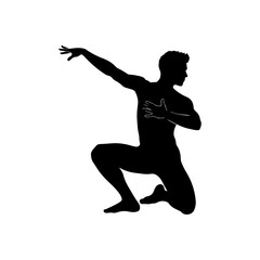 Silhouette of a male dancer in a dynamic kneeling pose. © Erik
