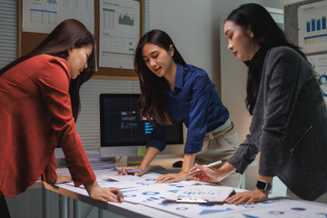 Fototapeta premium Businesswomen analyzing data working late night in office