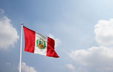 Naklejka premium Peru national flag waving in sky.