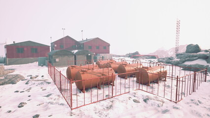 In a remote arctic area, red storage tanks are surrounded by snow. Nearby buildings stand against a backdrop of rugged mountains under a gray sky, highlighting the isolation of this site. © icetray