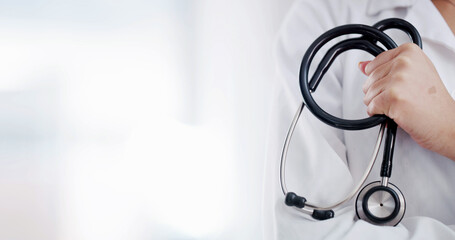 Space, stethoscope and hands of doctor in hospital for medical service, health insurance and wellness. Healthcare, mockup and person with equipment for cardiology, heart specialist and clinic career