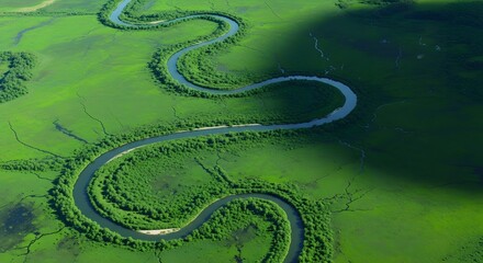 Obraz premium World environment day serpentine river winding through lush green landscape