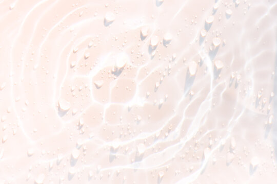 White water with ripples on the surface. Defocus blurred transparent white colored clear calm water surface texture with splashes and bubbles. Water waves with shining pattern texture background.