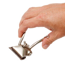 Old metal manual hair trimmer for barber in hand on white background