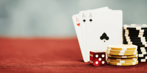 Gambling table featuring playing cards, dice, and stacks of poker chips, representing games of chance and fortune