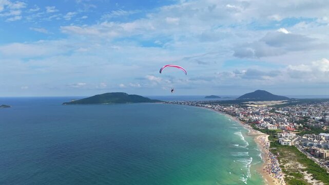 Aerial view of Powered Paraglider Over Florian&oacute;polis Beach Cityscape, Praia dos Ingleses, Adventure Tourism