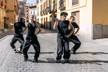 Dancers moving in sync on a city street, expressing urban culture and freedom through performance art