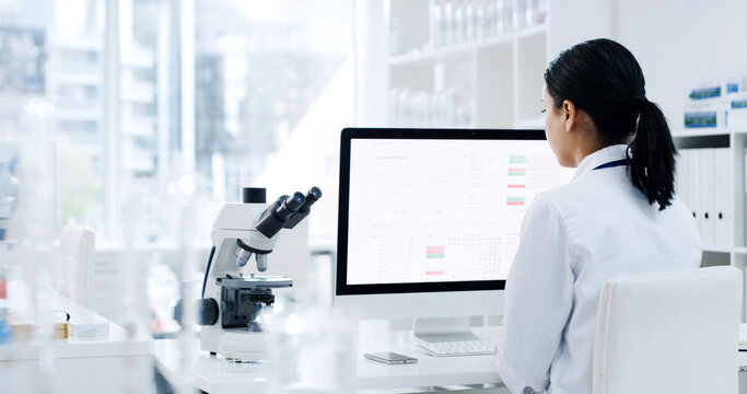 Back, woman and scientist with computer in lab for research, experiment and medical report. Female person, reading and pc screen with schedule, investigation results and information for vaccine study