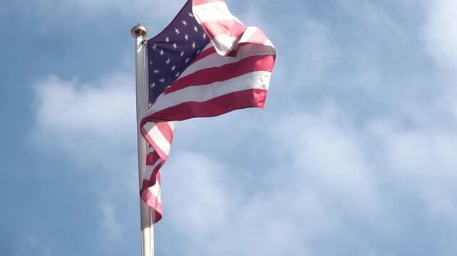 American flag waving on blue sky. United States flag. Flag in wind.. USA national symbol. Freedom and democracy. Independence day. Stars and stripes. Waving USA flag. 