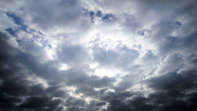 Dramatic Sun Rays Breaking Through Dark Storm Clouds