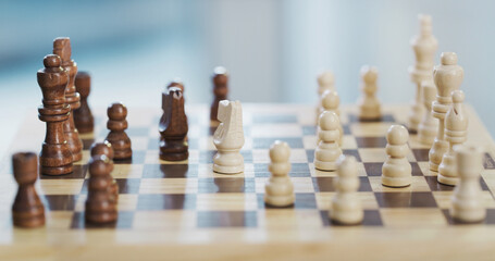 Naklejka premium Chess, board and pieces with game start for challenge, problem solving and competition on table. Chessboard, knight and queen with pawns in home for strategic hobby, tournament and boardgame contest