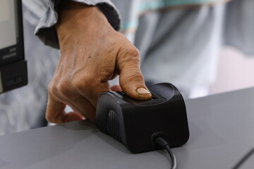 Fototapeta premium Fingerprint collection for a passport is a biometric process to verify identity. An officer scans the applicant’s fingerprints digitally, and the data is securely stored in the passport’s chip.