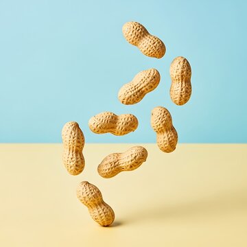 Eight peanuts floating in midair against a colorful background