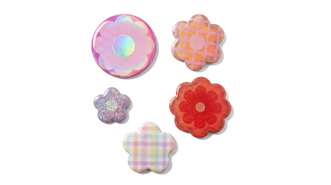 assortment of decorative holographic flower and circular stickers with glitter and plaid textures, set against a black backdrop.