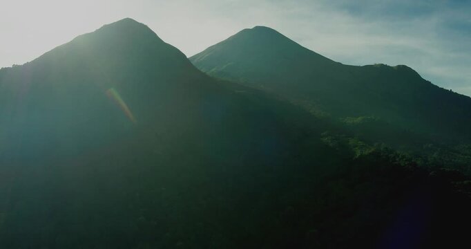 Drone Aerial Shot of Tropical Mountains Lit by Morning Sunlight