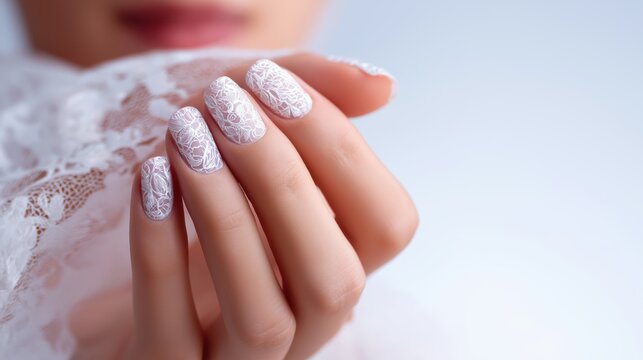 Woman holding lace with beautifully manicured white nails  