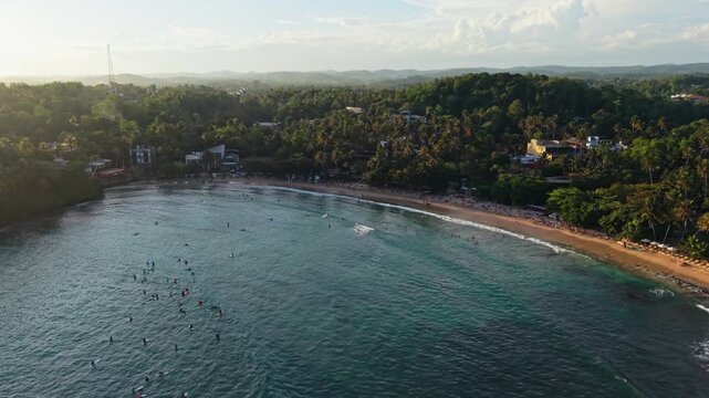 Sunset over the jungle of Hiriketiya beach in Sri Lanka