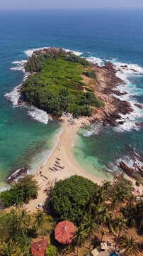 Vertical drone shot over blue beach Sri Lanka