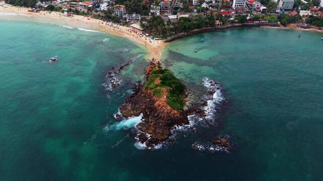 Aerial pan around parrot rock in Sri Lanka
