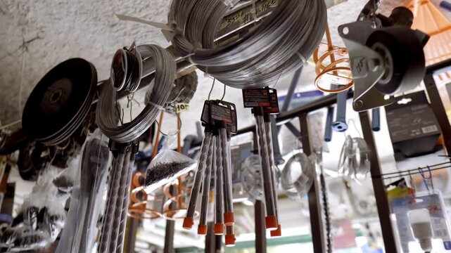 Various hardware items hanging in a store, focus on tools, indoor shot