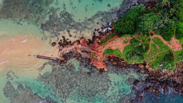Cinematic view of water surrounding an island at sunset