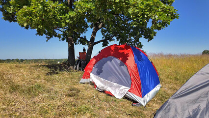 Camping in nature, enjoying outdoors in summertime.