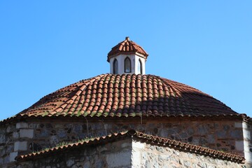 Traditional Stone Dome with Red Tiled Roof and Small Cupola