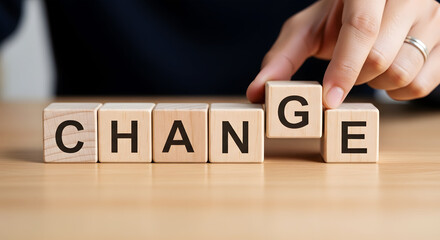 Naklejka premium Hand places wooden block spelling C H A N G E on table change word