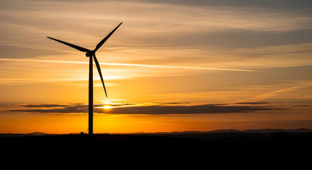 Obraz premium Wind Turbine Silhouette Against Dramatic Golden Sunset Sky