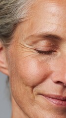 Fototapeta premium Mature woman finding joy, smiling with closed eyes, embracing natural aging process, showing authentic facial wrinkles and expressing happiness and peaceful relaxation