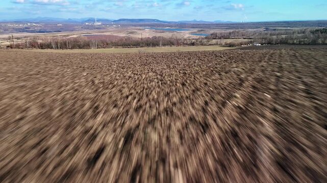Aerial drone flight over agricultural field landscape