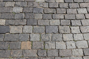 Obraz premium Weathered stone pavement surface with rough texture outdoors