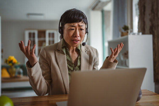 Frustrated businesswoman experiencing remote work burnout and communication problems