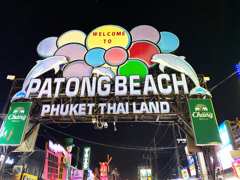 Phuket, Thailand - October 27, 2025: Welcome sign at Patong Beach in Phuket, Thailand illuminated at night with colorful lights and surrounding street scene visible