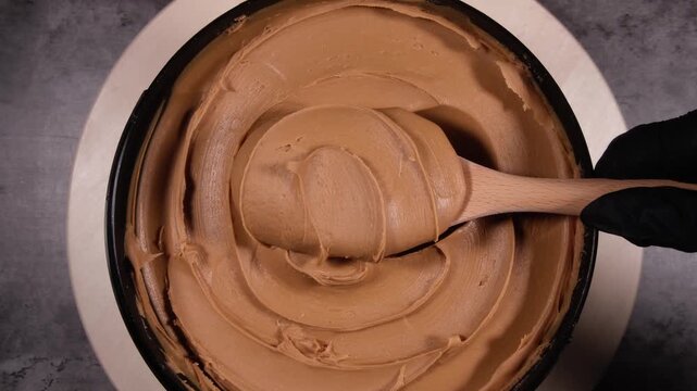 Vertical Close-Up of a Wooden Spoon Scooping Creamy Speculoos Cookie Butter - Aesthetic Thick Texture Reveal B-Roll