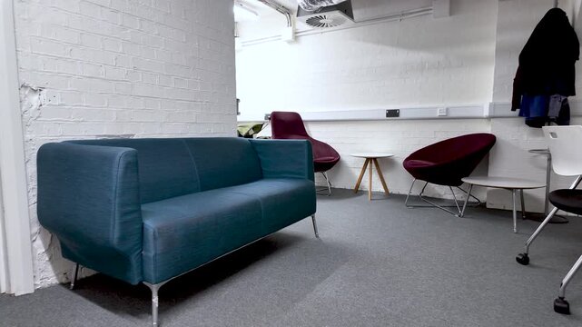 Office Downsizing And Remote Work Transition Empty Seating In Basement Office Space Corporate Restructuring And Workplace Changes Modern Furniture.