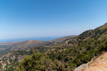 Scenic view of Crete mountains overlooking the blue sea on a sunny day