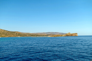 Exploring the tranquil waters and coastline of Crete, Greece under clear blue skies